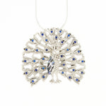 Load image into Gallery viewer, Silver necklace with a peacock feather design and blue stones on a white background