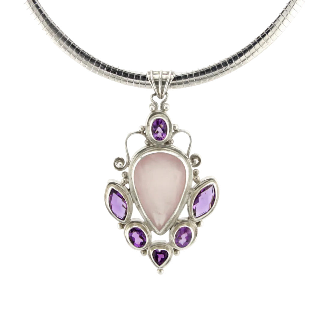 Necklace with a pendant featuring a pink stone and purple gemstones on a white background