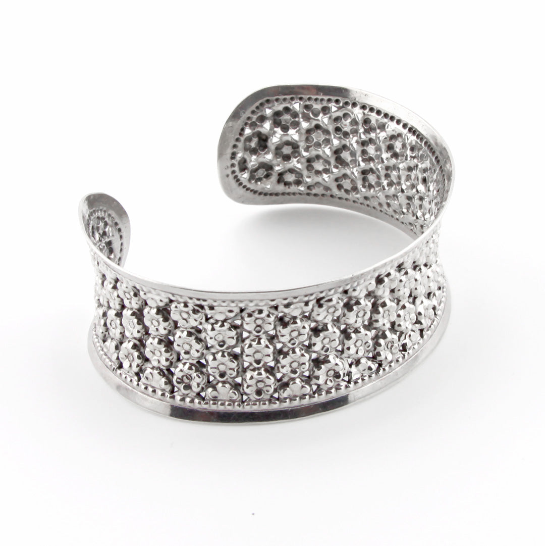 Silver open cuff bracelet with embedded stones on a white background