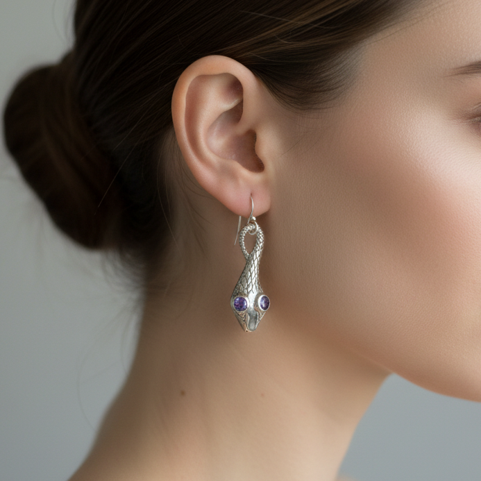Tanzanite eyes in a silver snake design drop earrings