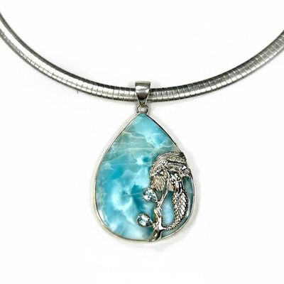 Teardrop-shaped pendant with mermaid design on a white background